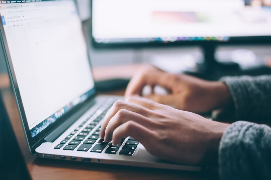 A person typing on computer